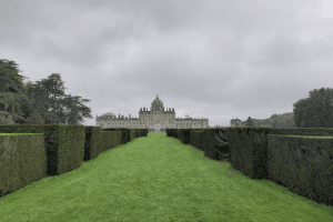 manicured lawns and hedges leading up to Castle Howard in the middle distance